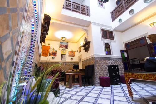 a lobby of a restaurant with a table at Hostel Amir in Fez