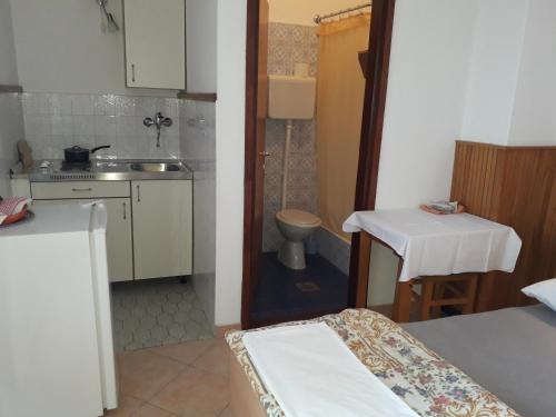 a small bathroom with a sink and a toilet at Apartmani Ana Novi V. - studio in Novi Vinodolski
