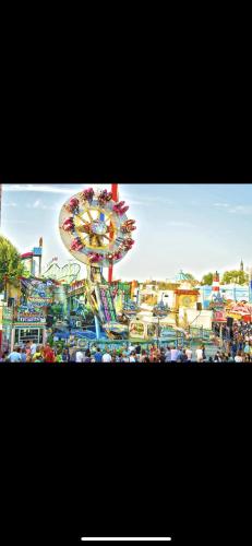 a carnival with a ferris wheel and many rides at Hotel Restaurant Zum Landmann in Wenden