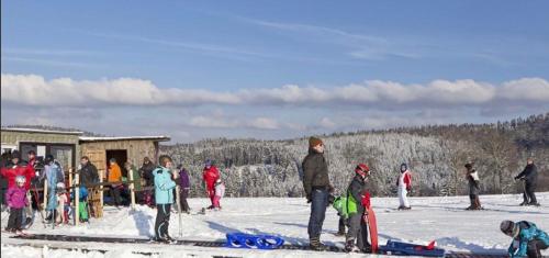 a group of people standing around in the snow at Hotel Restaurant Zum Landmann in Wenden