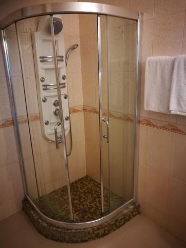 a shower with a glass door in a bathroom at Aparthotel Afrodita 2 in Sinemorets