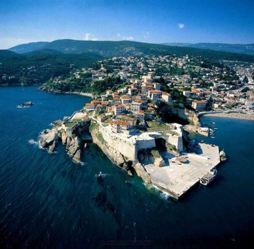 an island in the water with a town on it at Olive Garden in Ulcinj