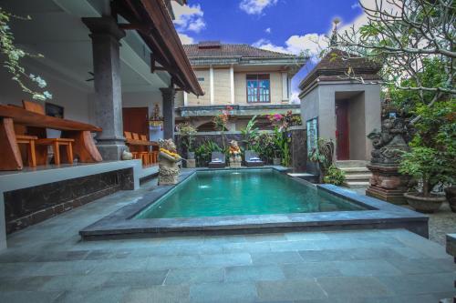 een zwembad in de achtertuin van een huis bij Satya House Ubud in Ubud