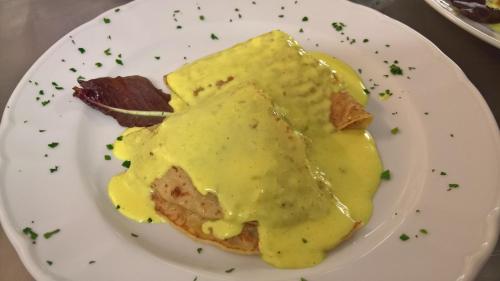 a plate of food with a pile of yellow sauce at Hotel Ristorante alla Campagna in San Giovanni Lupatoto