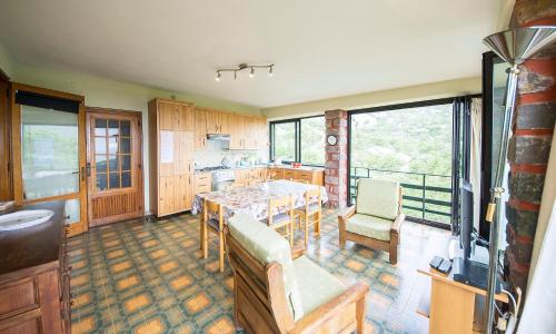 a kitchen with a table and chairs in a room at La bouganville Apartments in Cala Gonone