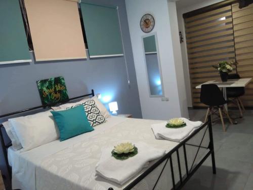 a bedroom with a bed with two plates on it at Summer Studio - Zakynthos!! in Argassi