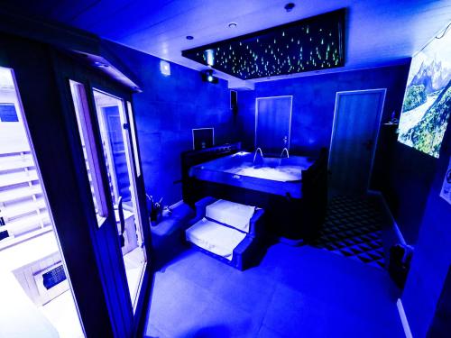 a blue bathroom with a sink and a mirror at Gites Spa Strasbourg - La Villa 15 in Ittenheim