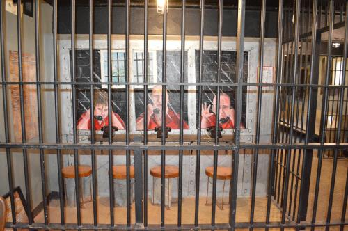 a cage with two men taking pictures in a mirror at The King George Inn in Cobourg