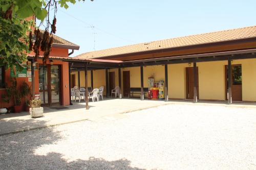 a building with a patio and tables and chairs at Agriturismo La Fraterna in Tolle