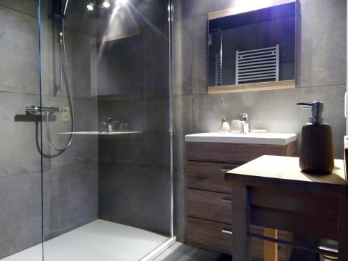 a bathroom with a glass shower and a sink at Votre Horizon in Aywaille
