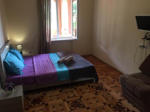 a bedroom with a bed with a stuffed animal on it at Guest House Marani in Sighnaghi