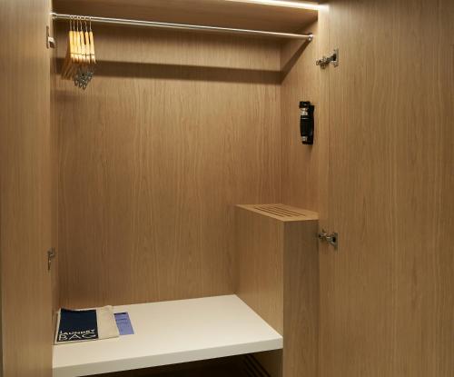 a room with a closet with a shelf and a door at OZO Phuket in Kata Beach