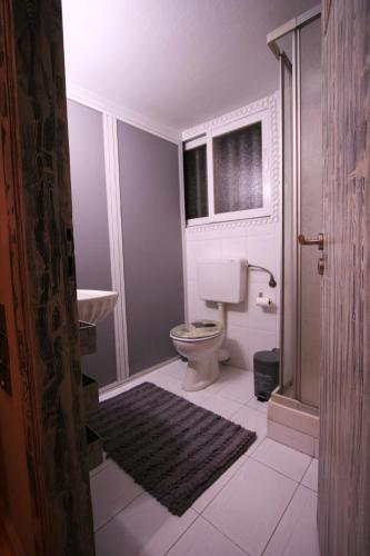 a bathroom with a toilet and a window at Flying Bed Ioannina in the center of the city in Ioannina