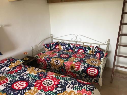 a bed with a comforter and pillows on it at Arancetodamare_POSEIDONE in Trebisacce