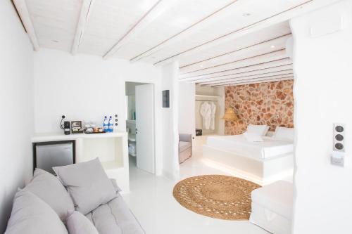 a hotel room with a bed and a desk at Paros Palace in Parikia