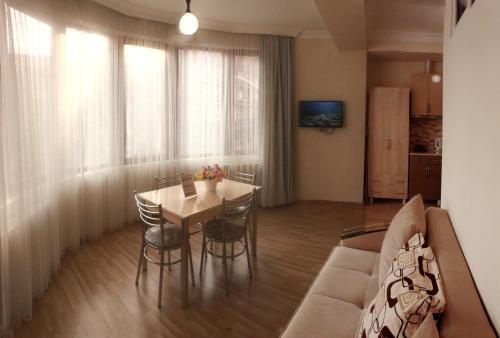 a living room with a couch and a table at Hotel Tao in Batumi