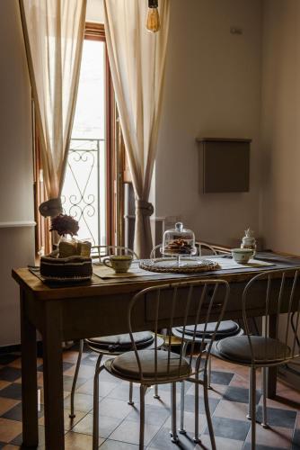 a dining room table with chairs and a window at Sacratum B&B Suite Spa in Mesagne