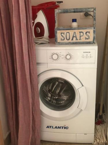 a washer and dryer in a room with a curtain at Baglio Mazzara in Custonaci
