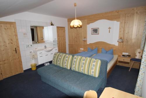 a bedroom with a large bed and a bathroom at Alpenbauernhof Gröbenhof in Fulpmes