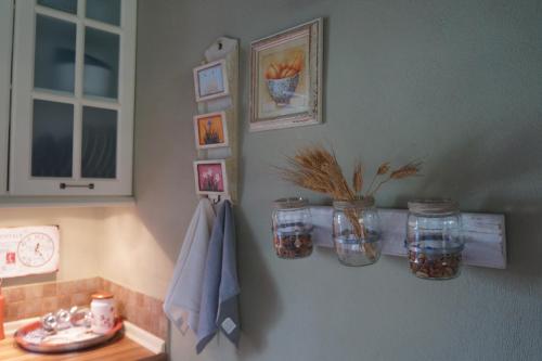 a kitchen counter with jars on a wall at Plane Tree House in Mákri