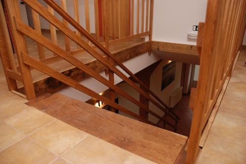 a staircase with wooden railings in a room at In Vino Bed & Breakfast in Pohořelice