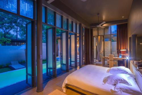 En eller flere senge i et værelse på SALA Phuket Mai Khao Beach Resort