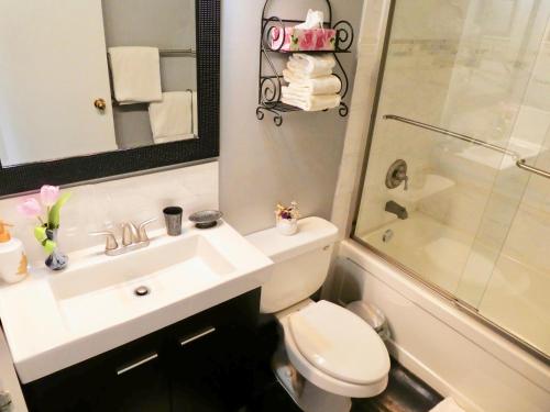 a bathroom with a sink and a toilet and a shower at Belle Neige Whistler in Whistler