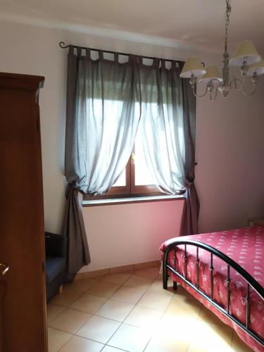 a bedroom with a bed and a window at Agricampolungo Monterosi in Monterosi