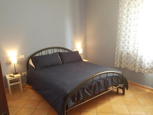 a bedroom with a bed in a room with a window at Agricampolungo Monterosi in Monterosi