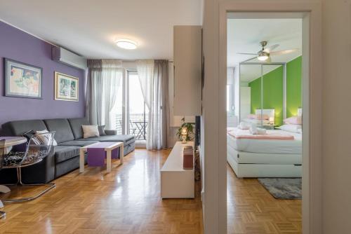 a living room with a bed and a couch at Apartman "Bubi" in Split