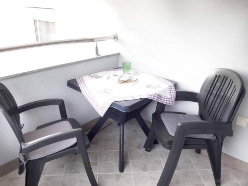 a small table with two chairs and a table with a drink on it at Apartments Nevistic in Tribalj