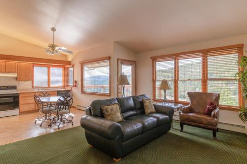 a living room with a leather couch and a table at Wildwood Inn in Estes Park