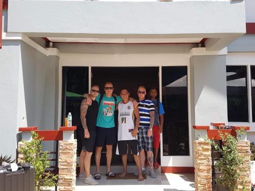 a group of people standing outside of a house at Catalina`s Inn family room in Panglao