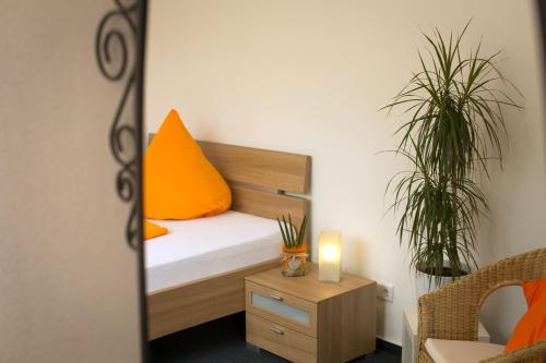 a bedroom with a bed and two potted plants at Hotel Emmerich in Winningen