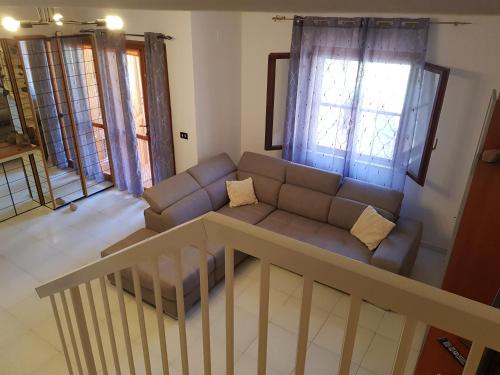 a living room with a couch and a table at Casa vacanze Valentina in Porto Conte
