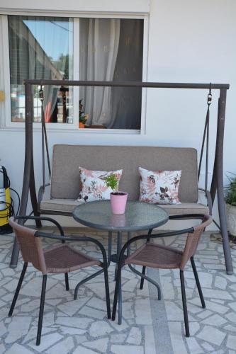 a patio with a table and chairs and a couch at Guest House Vera in Ulcinj