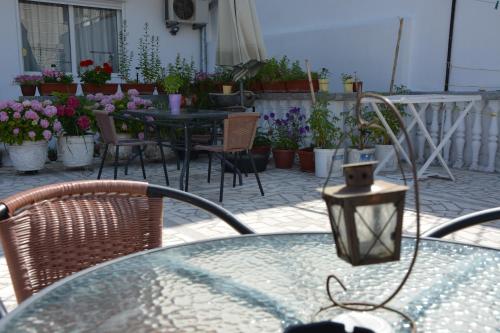 a patio with a table and chairs and flowers at Guest House Vera in Ulcinj