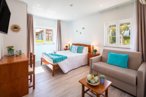 Ένα ή περισσότερα κρεβάτια σε δωμάτιο στο Apartamentos Flor da Laranja, Albufeira by AlgarveBlossom
