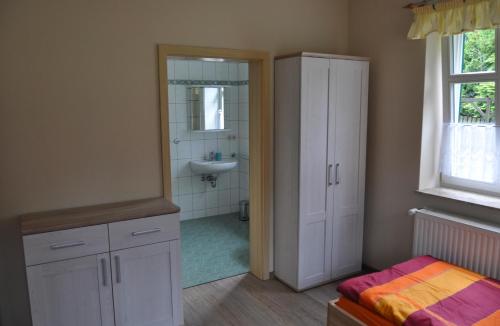 a bathroom with a sink and a toilet and a mirror at Hof Richert in Mellen