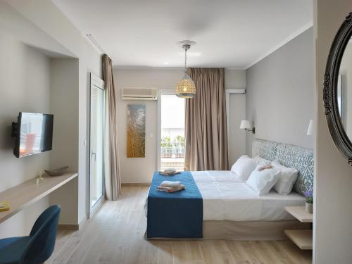 a hotel room with a bed and a tv at Lilly Apartments in Athens