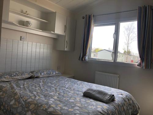 FlookburghにあるStatic caravan-Haven, Lake Districtのベッドルーム1室(ベッド1台、大きな窓付)