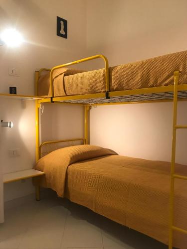 a bedroom with two bunk beds in a room at Casa Vacanze Ciullo d'Alcamo in San Vito lo Capo