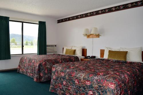 a hotel room with two beds and a window at Littletree Inn in Granby