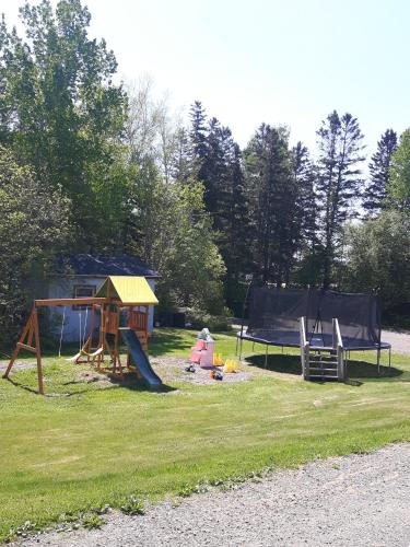 a park with a playground with a play equipment at Fair Isle Motel & The Nest in Whycocomagh