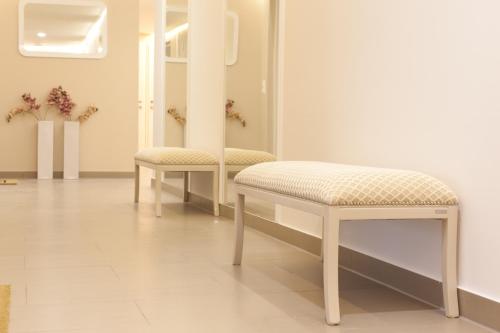 a dressing room with two chairs and a mirror at Sofie Apartments in Vienna