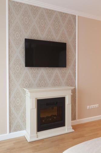 a fireplace with a flat screen tv on a wall at Sofie Apartments in Vienna