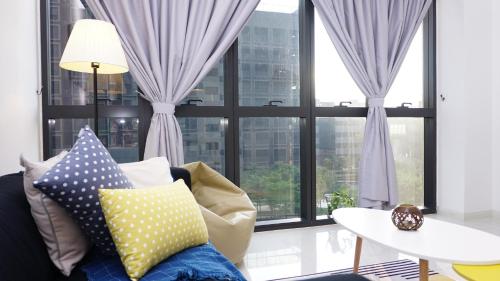 a living room with a couch and a large window at Orangerabbit@IconCity in Petaling Jaya