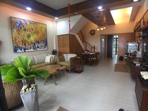 a living room with a couch and a table at Ciao Home in Toucheng