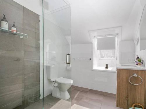 a bathroom with a toilet and a glass shower at Salt in Apollo Bay