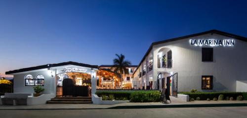 a white building with a sign on the side of it at La Marina Inn in San José del Cabo